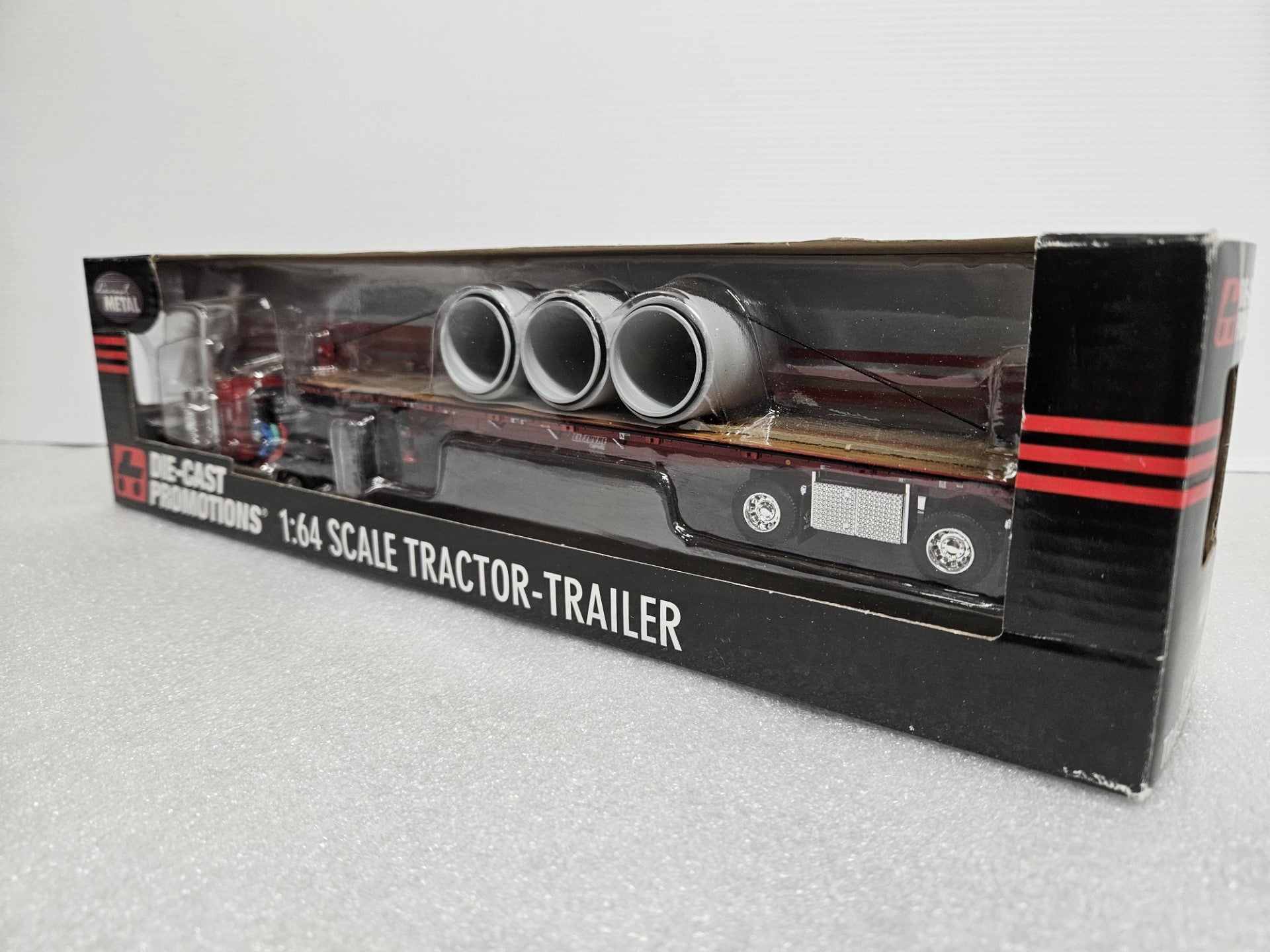Peterbuilt 379 Flattop with 3 (72) Drain Pipe Load on Wilson Flatbed 1:64