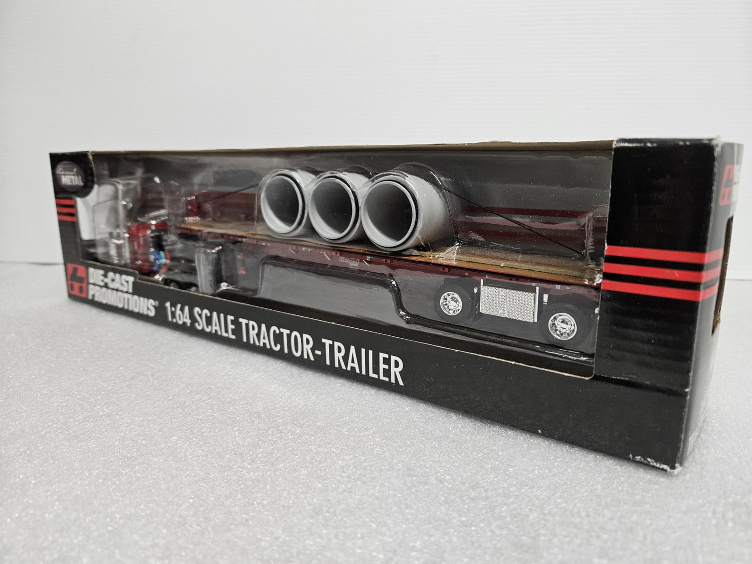 Peterbuilt 379 Flattop with 3 (72) Drain Pipe Load on Wilson Flatbed 1:64